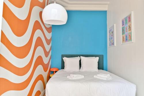 Katil atau katil-katil dalam bilik di Appartement central Montparnasse