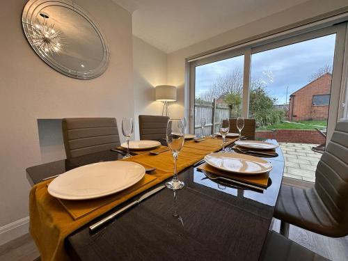 a dining room with a table with wine glasses at City centre home in Canterbury with free parking in Canterbury