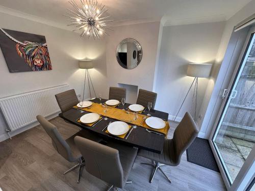 a dining room with a table and some chairs at City centre home in Canterbury with free parking in Canterbury