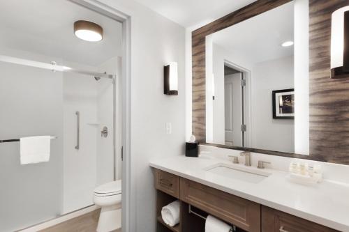 a bathroom with a sink and a toilet and a mirror at Homewood Suites by Hilton Providence Downtown in Providence
