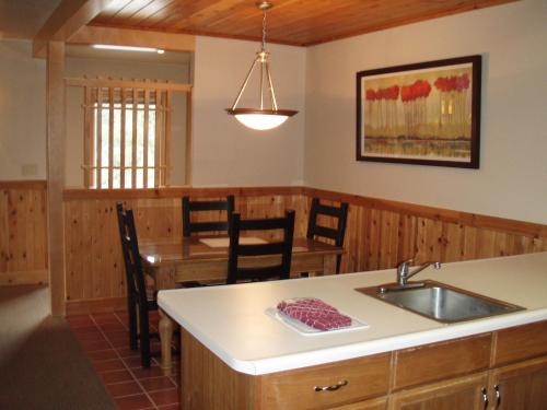a kitchen and dining room with a sink and a table at Mount Shasta Resort in Mount Shasta