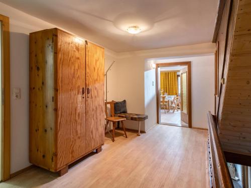 a room with a large wooden cabinet and a hallway at Urlaub am Stoffenhof in Wörgl