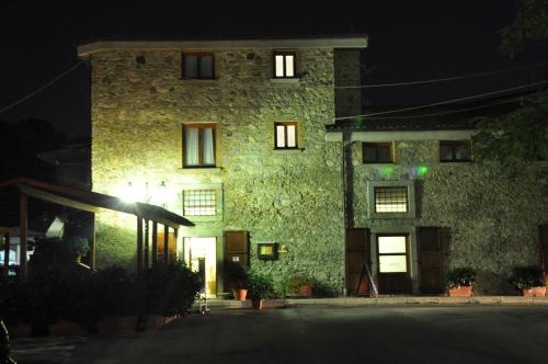 a large stone building at night with the lights on at Hotel Ristorante Antica Marina in Nicotera Marina