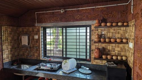 a kitchen with a sink and a window at Tiny Waves in Udupi