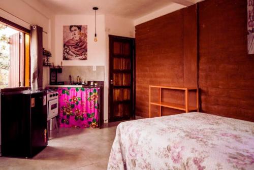 Zimmer mit einer Küche und einem Bett in einem Zimmer in der Unterkunft Daya Ma Hospedagem in Alto Paraíso de Goiás
