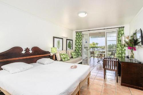 a bedroom with a large white bed and a desk at Village Sainte Luce, Martinique - maeva Home - Studio 3 personnes - Prestige MAE-2804 in Sainte-Luce