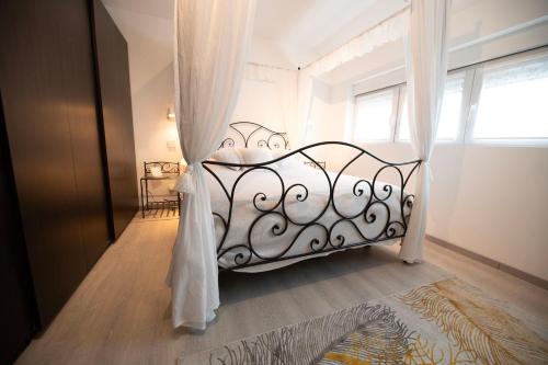 a white bed in a room with a window at LA PARENTHESE in Tournai