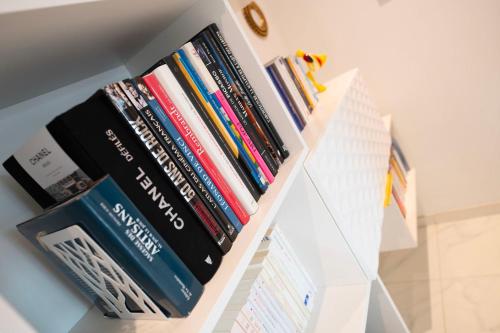 a shelf filled with books on a wall at LA PARENTHESE in Tournai