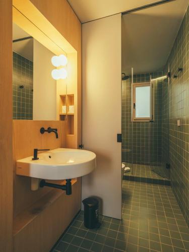 a bathroom with a sink and a shower at Boutique Apartments 23 Barcelona in Barcelona