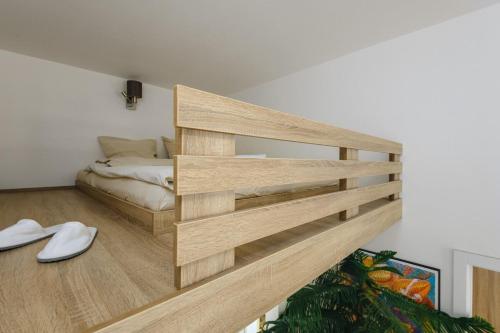 a room with a bed and a wooden shelf at Cozy & comfortable apt walking anywhere you want SEN in Prague