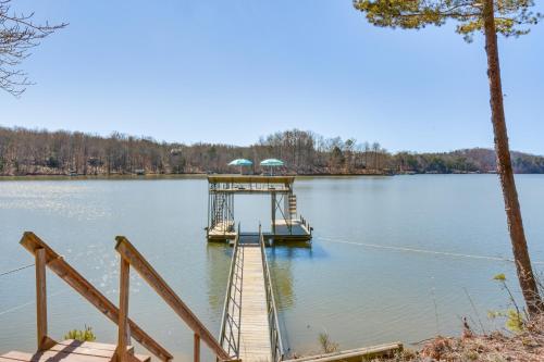 a dock with a boat on a lake at Lake Hartwell Retreat with 2-Tier Dock and Boat Slip! in Seneca