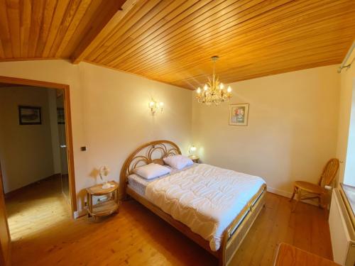 a bedroom with a bed and a wooden ceiling at Kerderff, longere entre plage et foret, TK30 in Carnac