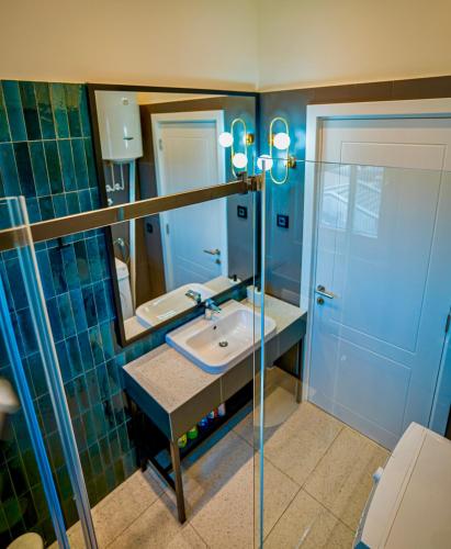 a bathroom with a sink and a mirror at Miha Premium Apartment 2BR 50m from Main Square in Belgrade