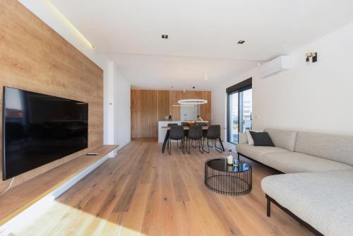 a living room with a couch and a table at FUX LUXURY Infinty-Pool Zadar in Zadar