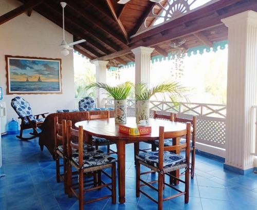 a dining room with a wooden table and chairs at A La Dolce Vita Beachfront Hotels, Las Terrenas, Samana in Las Terrenas