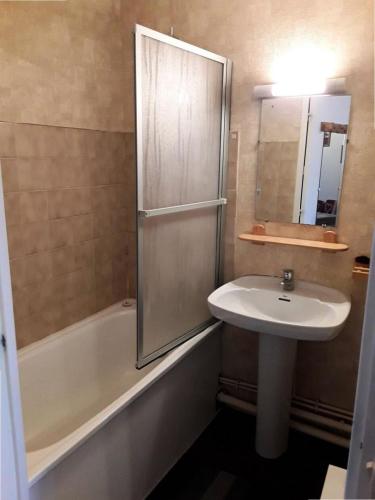 La salle de bains est pourvue d'un lavabo, d'une douche et d'une baignoire. dans l'établissement Résidence Cimes De Caron - Exposé sud, quartier calme pour 4 personnes MAE-2094, à Val Thorens