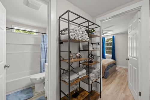 a bathroom with a black shelving unit next to a toilet at Downtown Dahlonega Destination in Dahlonega