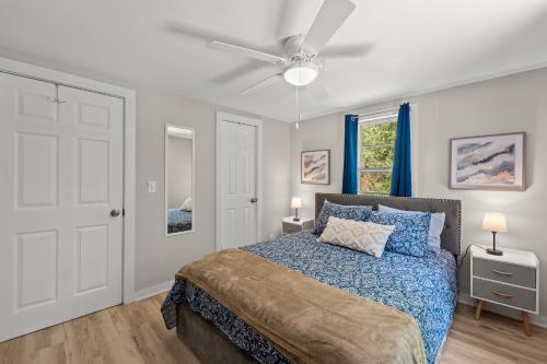 a bedroom with a bed and a ceiling fan at Downtown Dahlonega Destination in Dahlonega