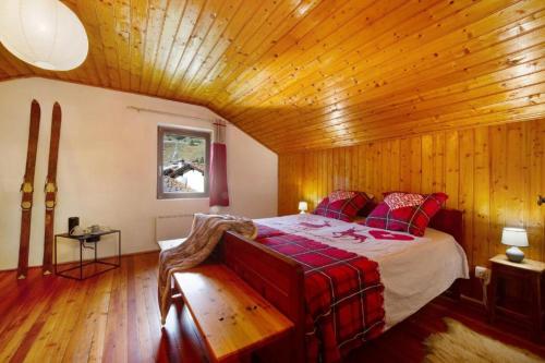 a bedroom with a bed in a wooden room at Alpine Majestic Escape - Balcone sulle Piste di Sci in Champoluc
