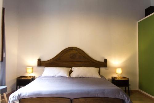 卡利亞里的住宿－La Nicchia，一间卧室配有一张大床和两盏灯