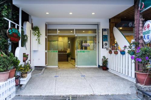 an entrance to a store with potted plants on the facade at Bei Pin B&B in Nanwan