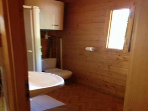 a bathroom with a sink and a toilet and a window at Chalet - Piscine - ef0aac in Porto-Vecchio