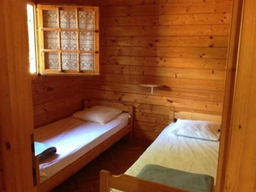 a room with two beds in a log cabin at Chalet - Piscine - ef0aac in Porto-Vecchio