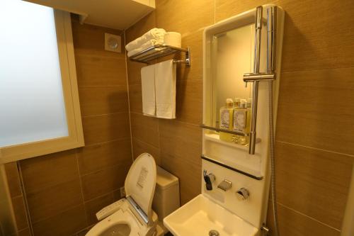 a small bathroom with a toilet and a window at Philstay Dongdaemun Economic in Seoul