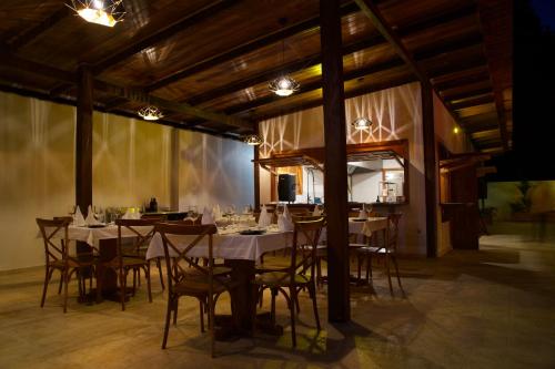 a dining room with tables and chairs and lights at Ciel y Miel in Colón