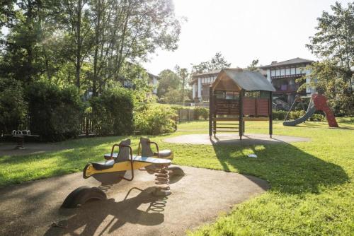 a park with a playground with a toy airplane and a play structure at Résidence Le Parc d'Arradoy - maeva Home - Appartement 2 pièces 5 personnes - Sélection MAE-2374 in Uhart-Cize