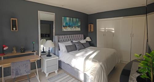 a rendering of a bedroom with a bed and a desk at Tranquil Pool View in Cape Town