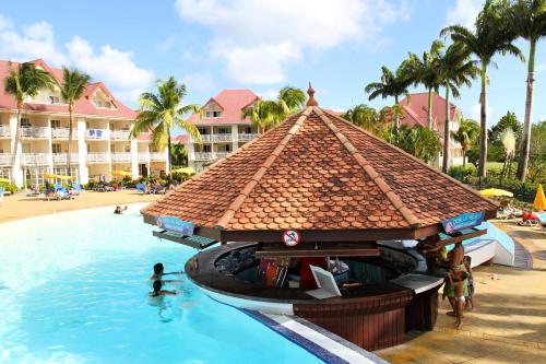 a pool at a resort with people in the water at Village Sainte Luce, Martinique - maeva Home - Studio 4 personnes - Sélection MAE-6594 in Sainte-Luce