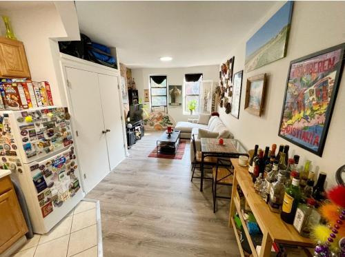 a room with a kitchen and a living room with a refrigerator at Charming One-Bedroom Apartment in South Chelsea in New York