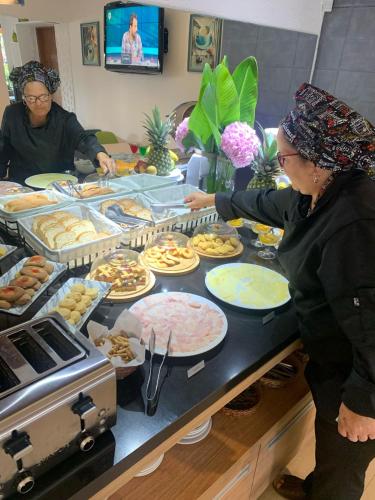 a woman is preparing food on a table at Hotel Bahia in La Paloma