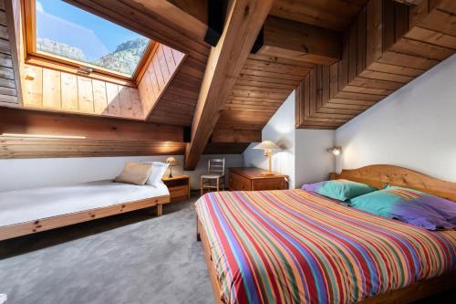 a bedroom with two beds and a large window at Residence Calabourdane - 3 Pièces pour 7 Personnes 714 in Val-d'Isère