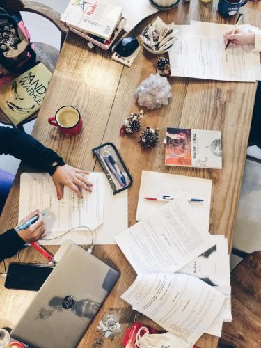a group of people sitting around a table with papers at Lin's Inn in Ruisui