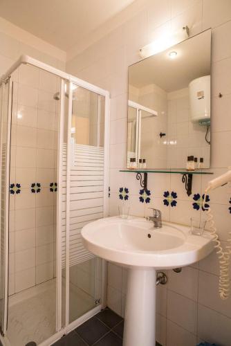a bathroom with a sink and a shower at Life Hotels Residence dei Baroni in Siracusa