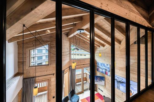 a room with wooden walls and a large window at Résidence Chantemerle - 5 Pièces pour 8 Personnes 344 in Courchevel