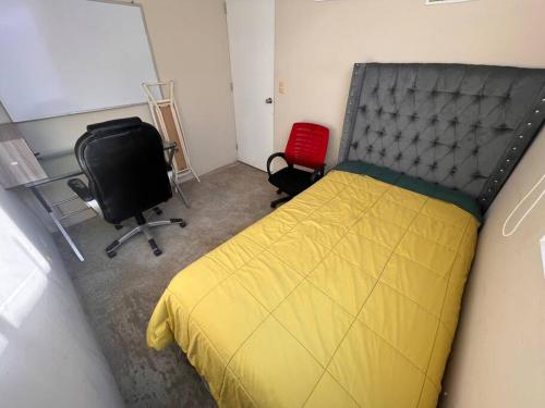 1 dormitorio con cama, escritorio y silla en Cómoda y acogedora casa de 1 piso en Trujillo