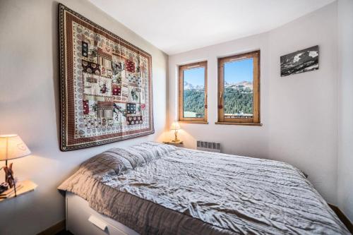 Een bed of bedden in een kamer bij Résidence Les Cimes Blanches - 2 Pièces pour 4 Personnes 564