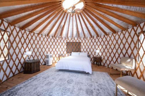 a bedroom with a white bed in a yurt at EagleWatch Mountaintop Yurt in Bryson City