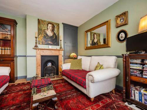 a living room with a couch and a fireplace at Finest Retreats - The Old Sunday School & Vestry in Cromer