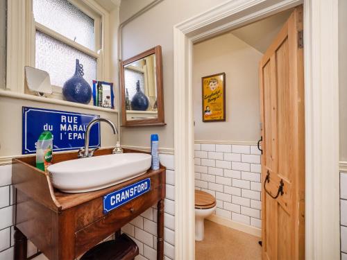 a bathroom with a sink and a toilet at Finest Retreats - The Old Sunday School & Vestry in Cromer