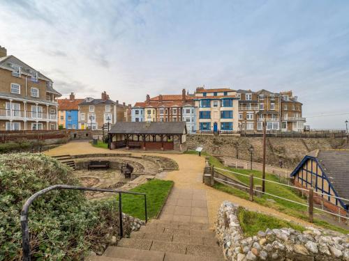 a group of buildings in a city with stairs at Finest Retreats - The Old Sunday School & Vestry in Cromer