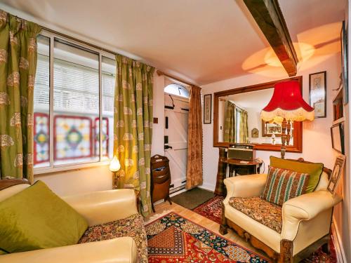 a living room with a couch and a chair and a window at Finest Retreats - Lychgate Cottage in Mattishall