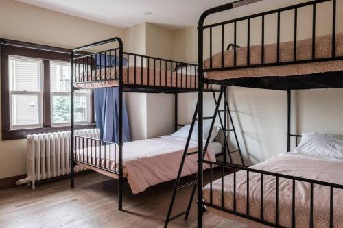 a room with two bunk beds and a window at Duff Heritage House in St. John's