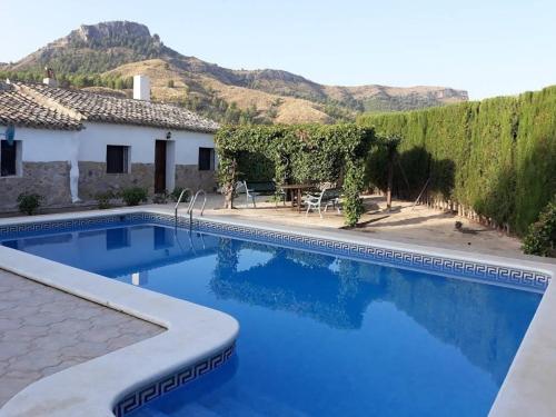 a swimming pool in front of a house at El Cabezo de la Torre in Cieza