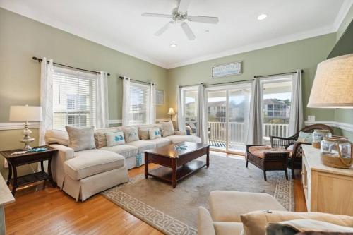 a living room with a couch and a table at 93 Waters Edge - Townhome - Pool in Folly Beach