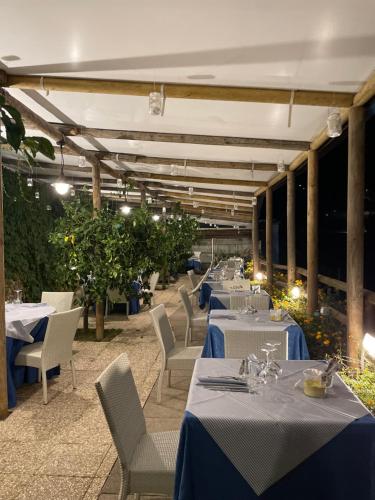 a row of tables and chairs at a restaurant at Villa Pino in Furore