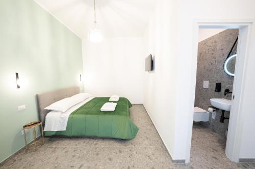 En eller flere senge i et værelse på Dimora Porcelli